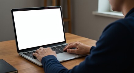 Close-up of hands using laptop with empty screen for UI testing or software interface mockup in home office
