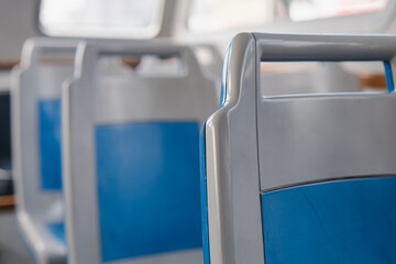 Empty bus interior showcasing modern seat design in urban transit environment