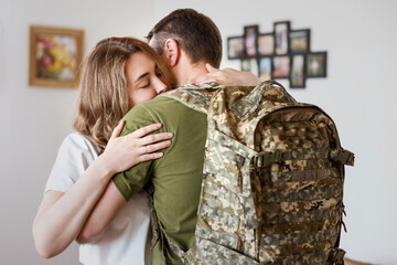 Military Ukrainian Soldier Embraces Wife Before Leaving for Duty. Sad Farewell Between Military Man and His Wife at Home