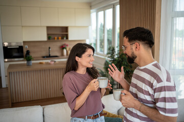 Couple enjoying coffee and conversation in modern kitchen