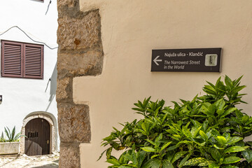 The narrowest street in the world, a narrow passage between the high walls of the old town, KRK in...