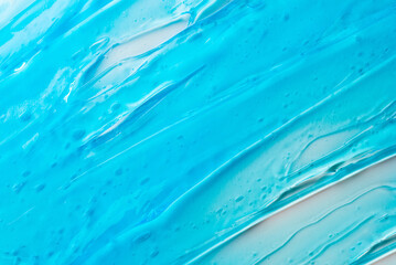 The texture of a blue cosmetic gel on a white background