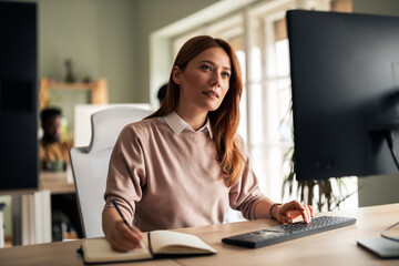 Professional Woman Working at Computer in Modern Office Environment