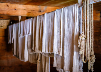 Colorful clothes drying on a line amidst lush green grass in a rural area during bright daytime