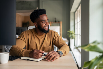Smiling Professional at Work Desk in Modern Office Environment