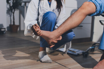 Physical therapist teaching a patient how to do exercises for his knee pain