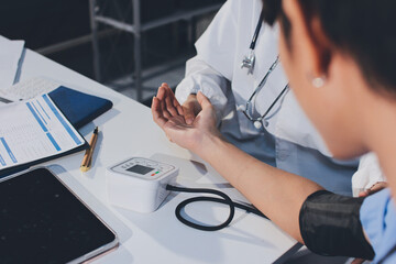 Doctor checking patient arterial blood pressure in hospital. Health care Concept