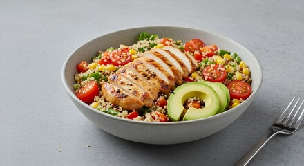 Savor the vibrant flavors of this healthy quinoa chicken salad, perfectly complemented by avocado and cherry tomatoes.