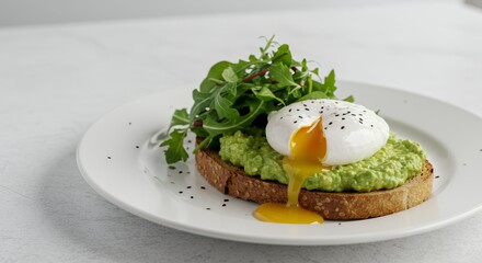 Indulge in this vibrant avocado toast topped with a perfectly poached egg, a culinary masterpiece for breakfast or brunch.