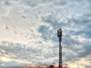 Cell Tower Silhouette Against a Dramatic Sunset Sky