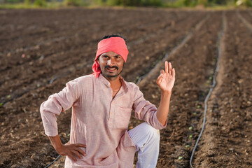 farmer sitting at agriculture field while drip irrigation complete