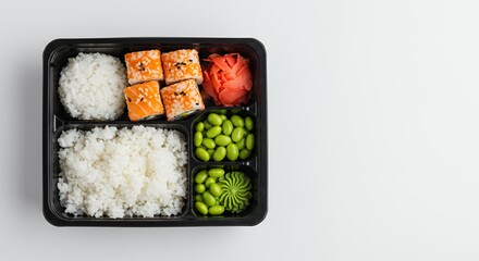Delicious Sushi Lunch Box: Fresh Salmon Rolls, Rice, Edamame, and Ginger