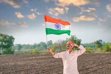 indian farmer waving national tricolor flag and saluting on independence day