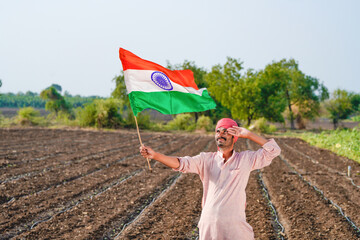 indian farmer waving national tricolor flag and saluting on independence day