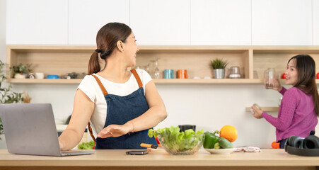 Healthy Cooking and Connection. Women enjoying healthy food preparation in a bright kitchen.
