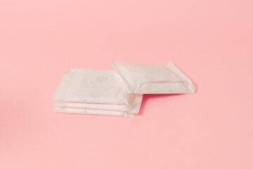 Flat layout of sanitary napkins on pink background. Menstruation cycle, feminine hygiene and...