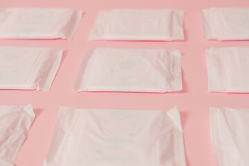 Flat layout of sanitary napkins on pink background. Menstruation cycle, feminine hygiene and...