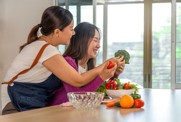 Healthy Meal Prep. Women enjoying cooking with fresh vegetables in a bright kitchen.