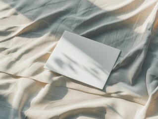 Fototapeta premium White card on beige fabric with shadows, PNG
