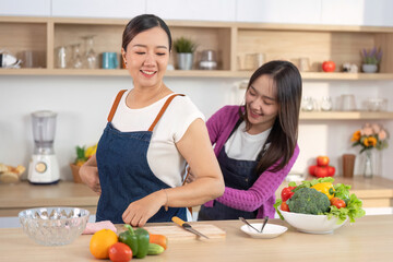 Joyful Cooking Experience: Women Enjoying Food Prep in Bright Kitchen