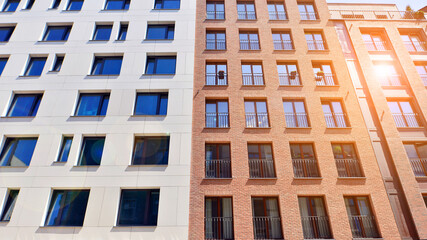 Modern apartment buildings on a sunny day with a blue sky. Facade of a modern apartment building....