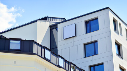Modern apartment buildings on a sunny day with a blue sky. Facade of a modern apartment building....