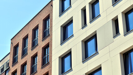 Modern apartment buildings on a sunny day with a blue sky. Facade of a modern apartment building. Modern residential apartment building complex condo.