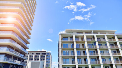 Exterior of a high modern multi-story apartment building - facade, windows and balconies.