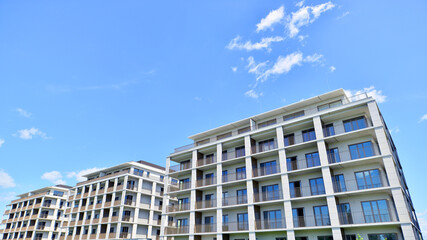 Modern apartment buildings on a sunny day with a blue sky. Facade of a modern apartment building....