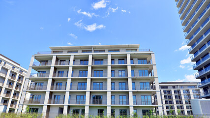 Modern apartment buildings on a sunny day with a blue sky. Facade of a modern apartment building....