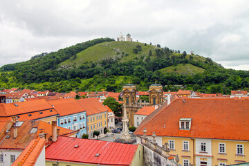  View from above from the castle to the main square and the Holy Hill with its Pilgrimage Chapel of St.Sebastian in background.  Town of Mikulov in South Moravian Region of the Czech Republic. 