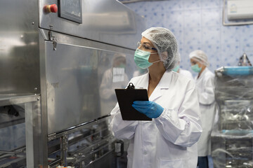 Drinking water production plant. 20 Liter bottled water filling machine plant. Workers inspect operation and control working mechanism of the drinking water filling machine in drinking water factory