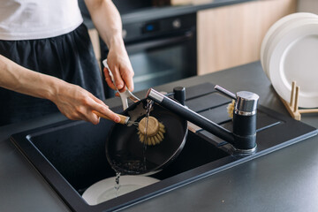 Sleek black countertop and efficient faucet in modern kitchen sink