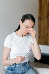Chronic illness affects woman feeling unwell in her living room at home
