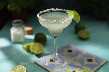 A glass with margarita cocktail with lime
