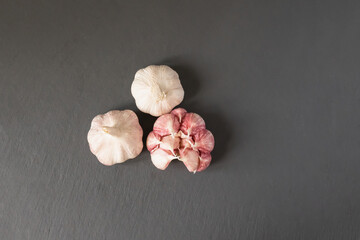 scattering of whole head of garlic in a dark  background