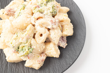 Cream Tteokbokki Korean Rice Cake with Bacon and Broccoli on White Background