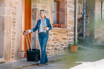 woman traveling walking with suitcase or luggage