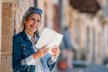 female traveler or tourist on the street with a map