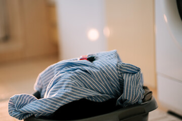 Cleaning dirty clothes in a home laundry space using a washing machine