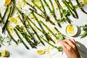 Grilled Asparagus With Lemon. Grilled asparagus dish garnished with lemon wedges and zest, a vibrant and fresh presentation.
