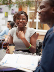 Teenage Students, Coffee Break. A pair of relaxed school friends chatting over coffee in their college refectory. From a series of related images.