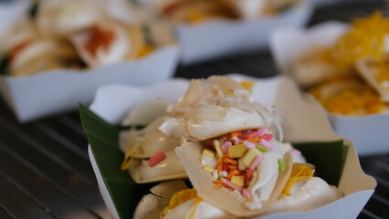 Khanom Buang - Thai traditional dessert, crispy pancakes   with cream and variety toppings, street food.