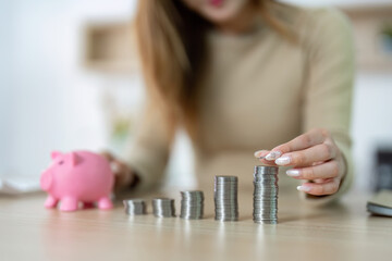 Wealth Management. Woman Stacking Coins Next to Piggy Bank