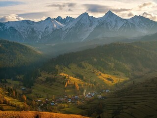 Tatras village in the autumn mountain valley. Autumn mountain village, with a beautiful autumn sun,...