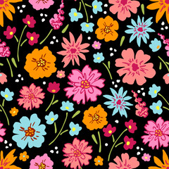 Obraz premium Bright summer flowers on a black background. Floral dark seamless pattern. For fabric prints, textile products.