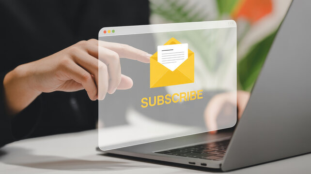 A laptop screen with a yellow envelope and a hand pointing to the word "subscribe" on the screen - Powered by Adobe