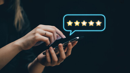 A woman is holding a cell phone with a star rating app on it. She is giving a thumbs up to the app
