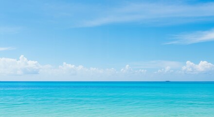 Obraz premium A Serene and Breathtaking Coastal Scene Showcasing a Clear Blue Sky and Tranquil Turquoise Waters Under Gentle White Clouds, Perfect for Relaxation and Inspiration