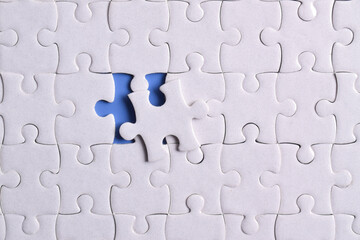 Missing jigsaw puzzle pieces and business concept on blue background. Completing final task